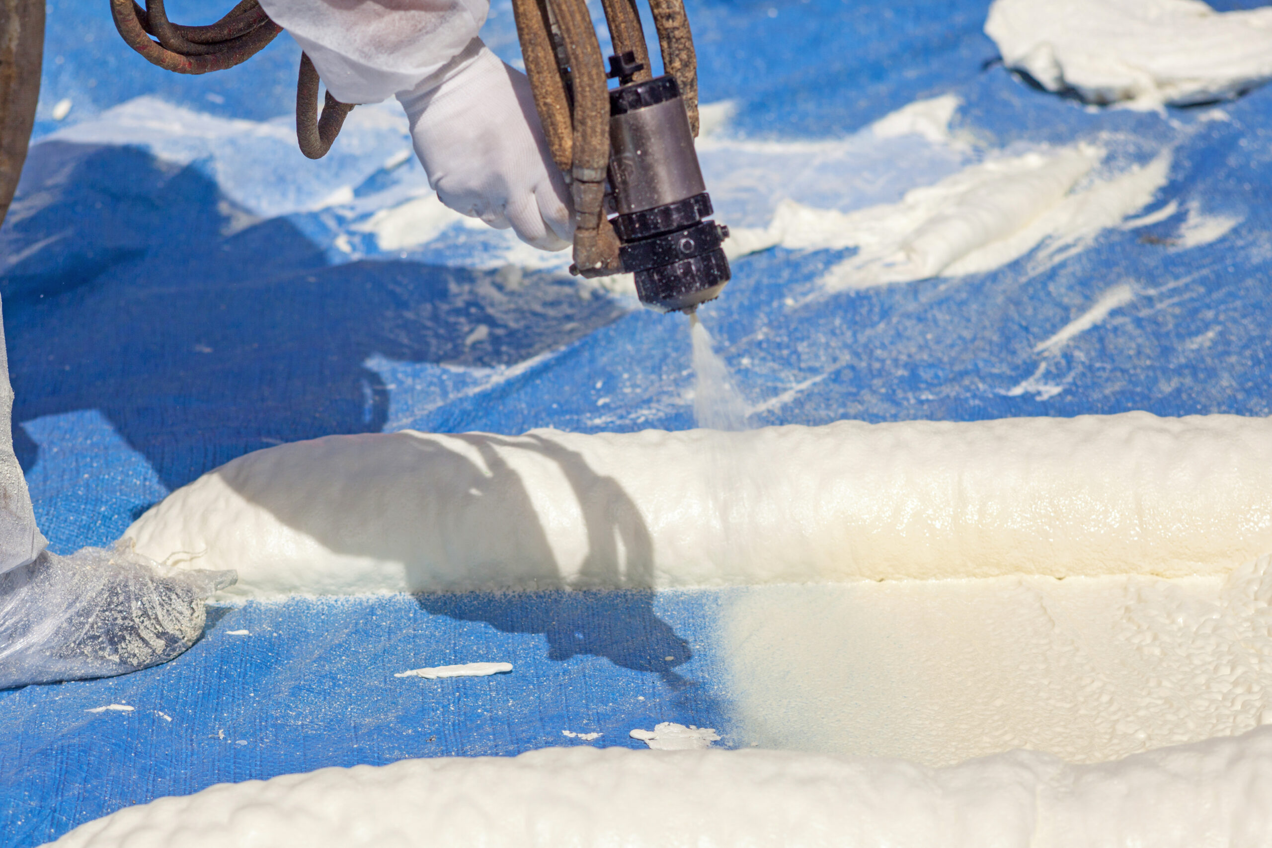 Technician,Dressed,In,A,Protective,White,Uniform,Spraying,Foam,Insulation