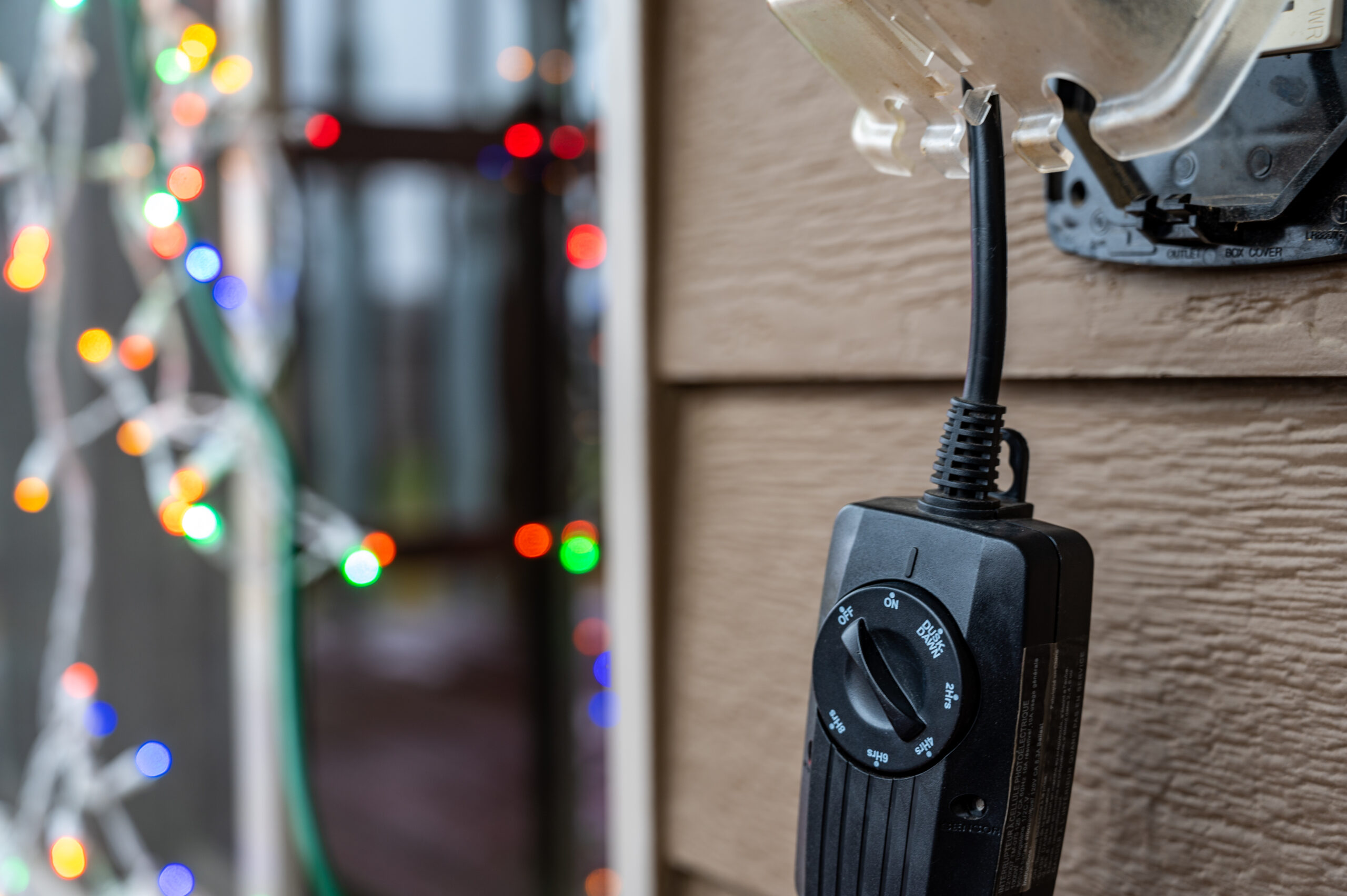 Outdoor,Timer,And,Gcfi,Outlet,With,Cover.,Blurred,Christmas,Lights