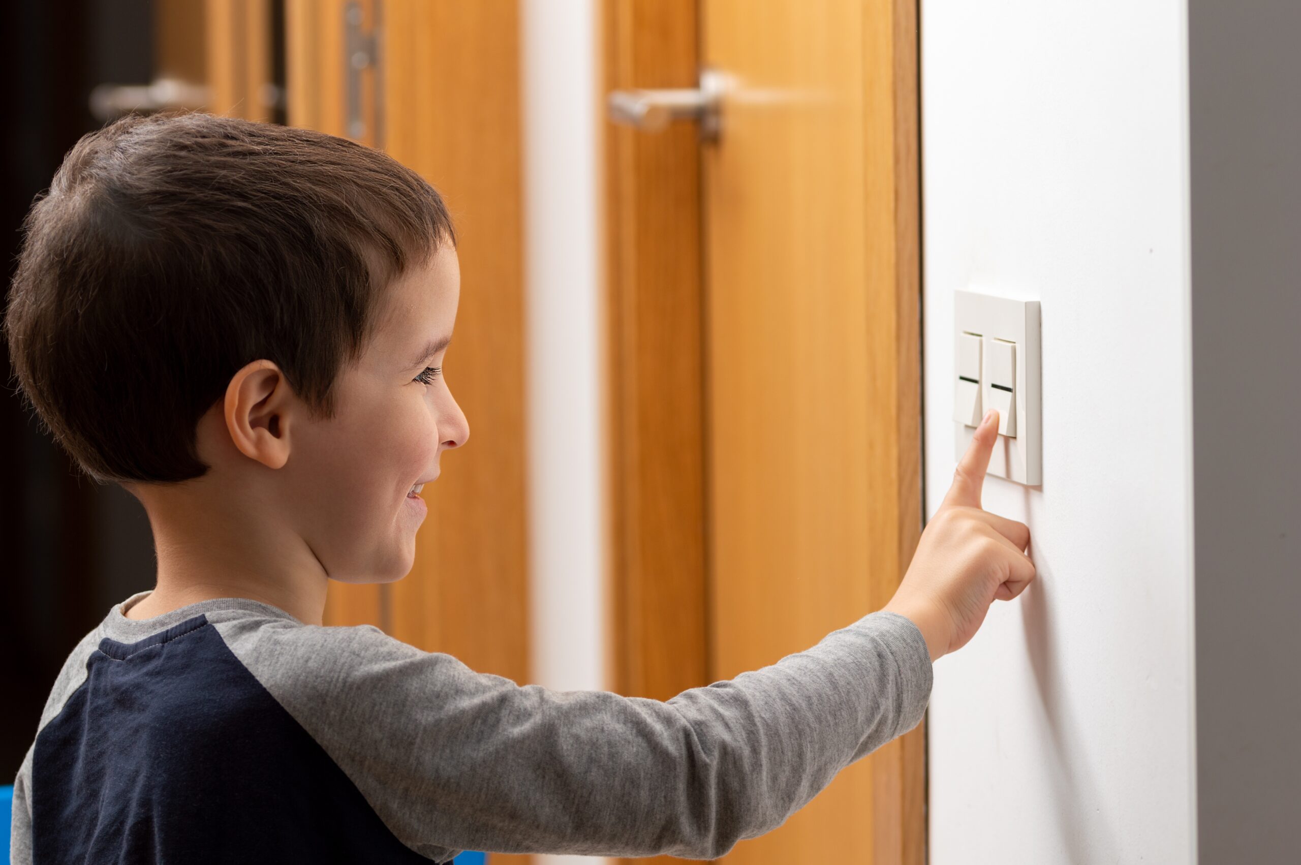 A,Cropped,Shot,Of,A,Little,Boy,Switching,A,Light