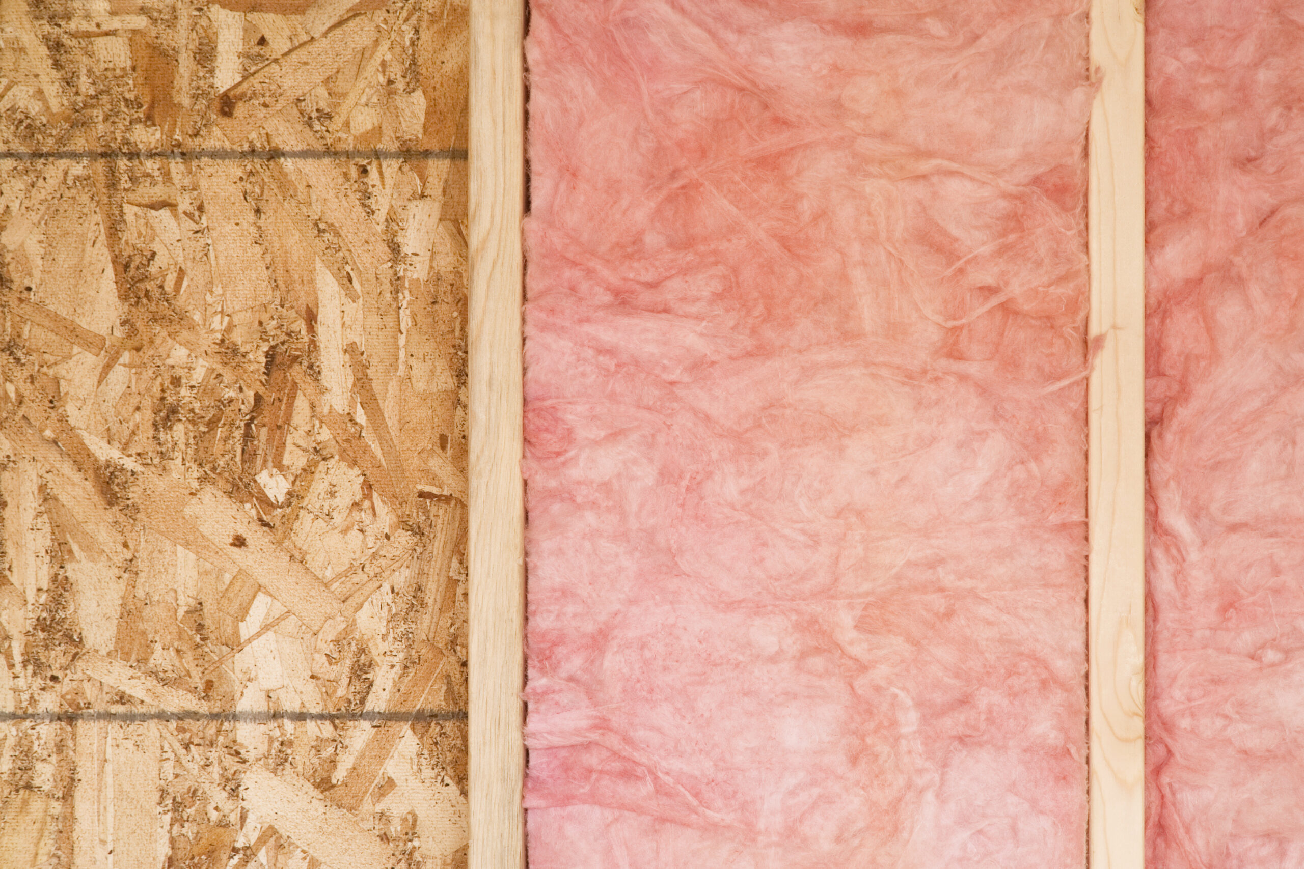 Close-up,Of,Strips,Of,Pink,Fiberglass,Insulation,In,A,Wall