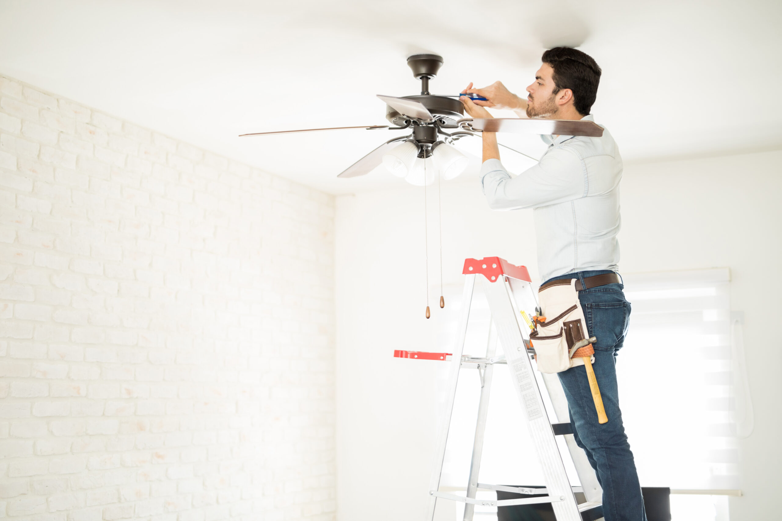 Profile,View,Of,A,Male,Electrician,Stepping,On,A,Ladder