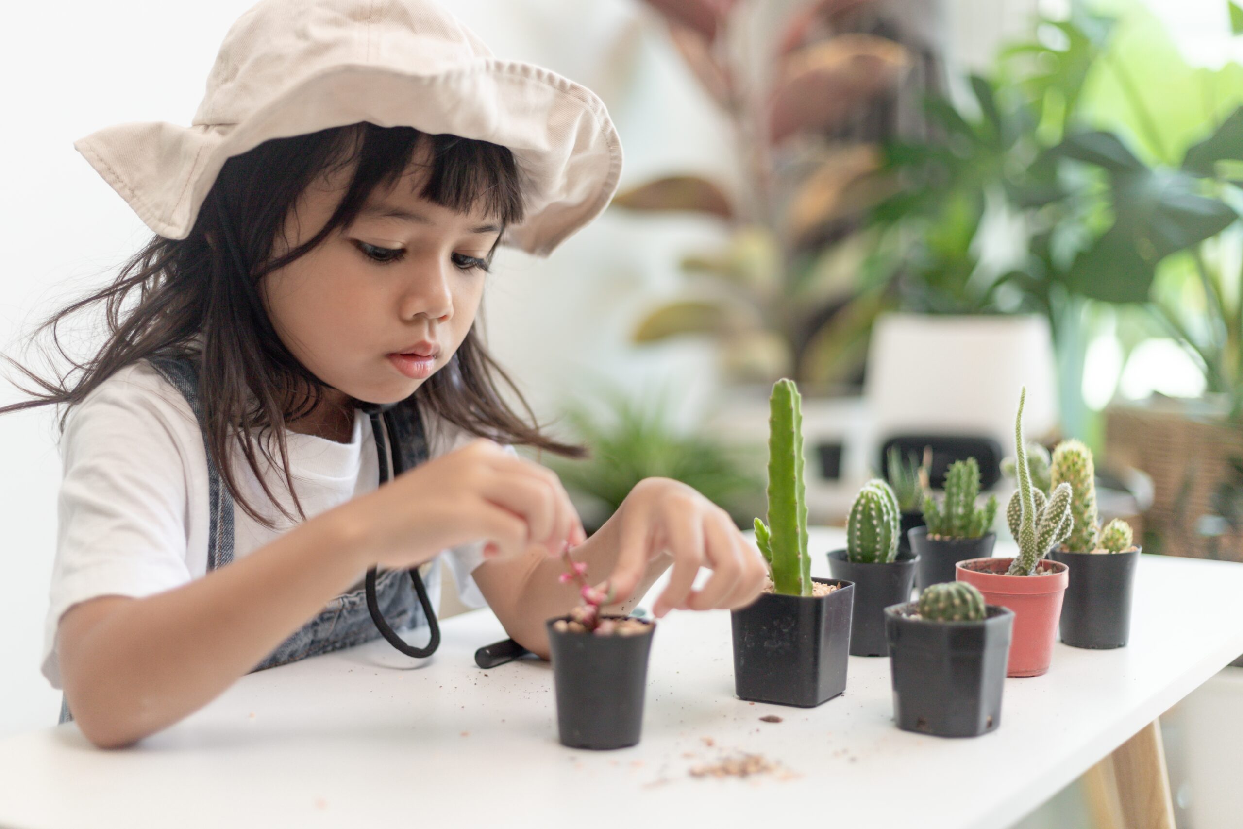 Kid,Gently,Touches,The,New,Stem,Of,The,Cactus,He